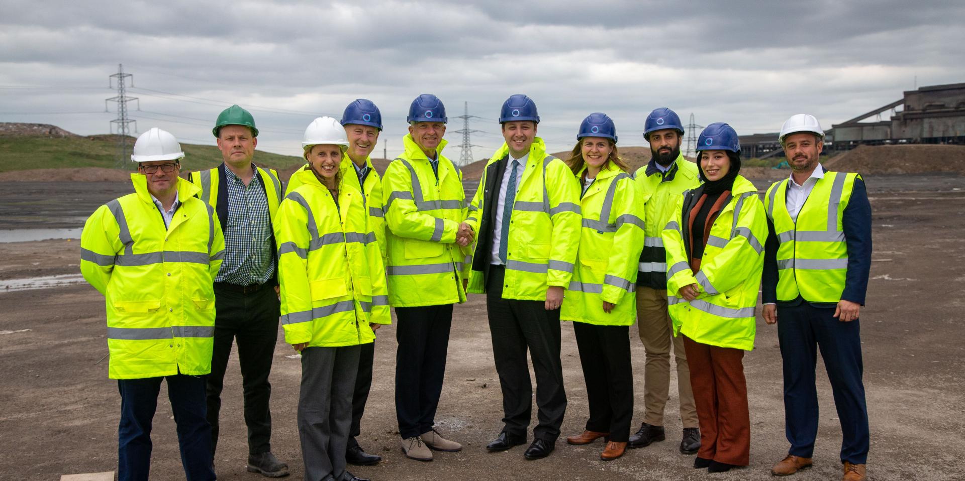 Mr Ben Houchen, Tees Valley Mayor (centre right) shaking hands with Søren Jacobsen, Dimeta CEO (centre left) at the Teesworks site with Matt Johnson, Teesworks, Development Director (far right) and other team members